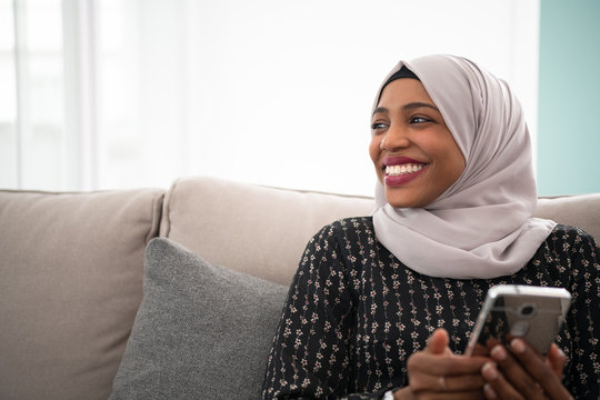 African  Woman Using Smartphone At Home