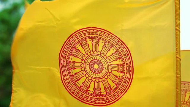 The yellow flag has the Dhammakaj wheel. Is a symbol of Buddhism Waving according to the wind1