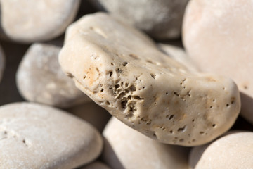 Stony beach by the sea, background of small stones, close up