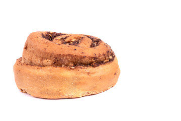 One isolated tasty cinnamon bun with nuts on white background