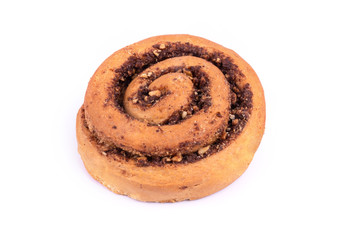 One freshly baked bun with nuts and cinnamon laying on white background
