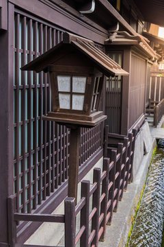 A traditional Japanese wooden lantern located in front of the house in Takayama, Japan.