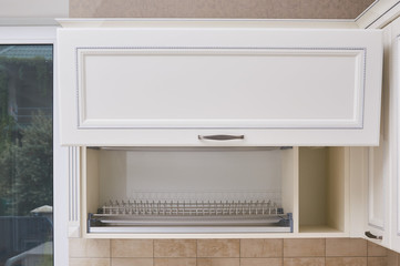 dish drying rack in Hanging cabinets with milling and cornices in white classic kitchen