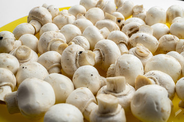 Tasty mushrooms on a wooden table. Mushrooms in the kitchen on a chopping board. Light background.