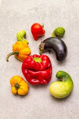 Fototapeta na wymiar Trendy ugly organic vegetables. Assortment of fresh pepper, eggplant, cucumber, tomato, pumpkin