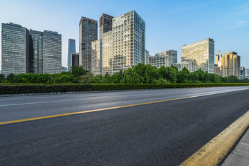 Fototapeta na wymiar Asphalt road and modern city commercial buildings in Beijing, China
