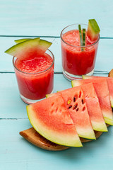 Fresh juice of watermelon, smoothie, cocktail. Sweet summer dessert, slices on wooden cutting board