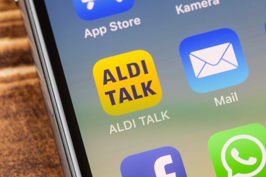 METTINGEN, GERMANY - NOVEMBER 9, 2018: Close up to ALDI TALK app on the screen of an iPhone X with personalized background