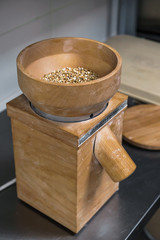 The process of making green buckwheat flour in a wooden hand mill in a small bakery