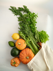 zero waste food shopping. eco natural bags with fruits and vegetables in tote, eco friendly, flat lay.