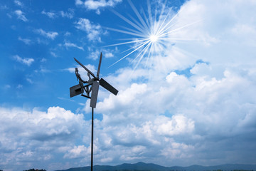 wind turbine against blue sky and clouds