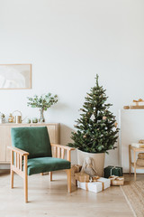 Scandinavian interior design apartments decorated in Christmas / New Year style with toys, gifts, fir tree. Festive winter holidays composition.