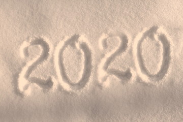 Abstract Christmas photo for beautiful Christmas card with background inscription 2020 on real white snow in winter in cold weather