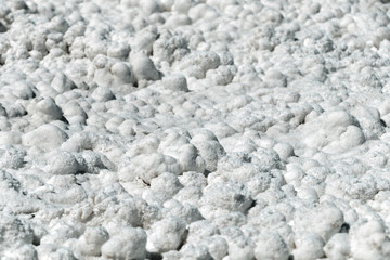 Salt crystals on the salty surface of desert close up. Natural background with copy space