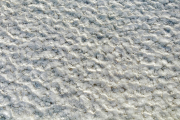 Salt crystals on the salty surface of desert close up. Natural background with copy space