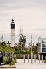 Lighthouse of the city of Calais in France overtaking roofs