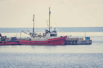 Small boats moored to the pier