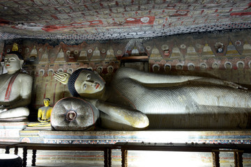 Statue of reclining Buddha in the ancient Buddhist cave temple at Dambulla, Sri Lanka.