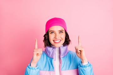 Photo of nice lady indicating hands up empty space wear warm colored coat isolated pink background