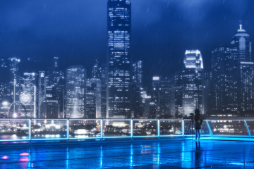 People stand in front of Victoria Harbor, Hong Kong at raining night