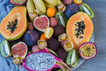 assorted exotic fruits on a gray background close-up