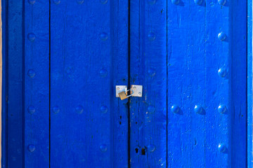 old blue wooden door with metallic lock