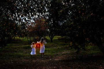 children frolic and shine wind lamps in the fall