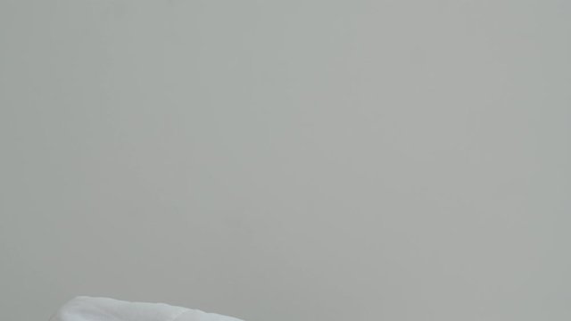 Slow motion - Asian young woman shocked as he wake up late for an appointment on bed in bedroom at home in morning. Beautiful Indian female missed ringing of alarm clock and have overslept awakening.