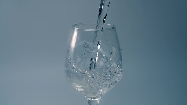 Cold water is poured to the glass in slow motion, liquid in 240fps, falling water, Full HD 240p Prores 422 HQ 10 bit