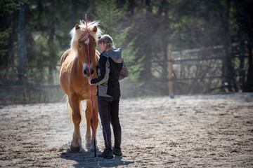 Horse and woman on riding field
