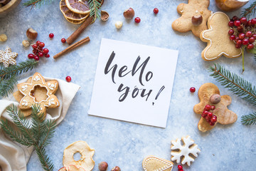 New Year and Christmas background with word Hello winter. Christmas candy cane gingerbread on black background.