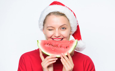 Christmas summer destinations. Christmas girl eat watermelon. Woman santa hat hold slice...