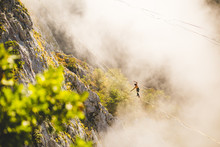 Highliner goes on a sling above the clouds.