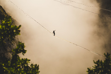 Highliner goes on a sling above the clouds.