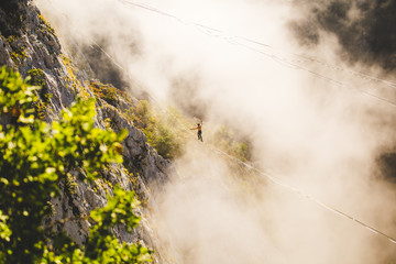 Highliner goes on a sling above the clouds.