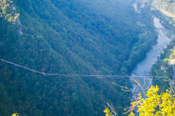A man walks confidently along the highline.