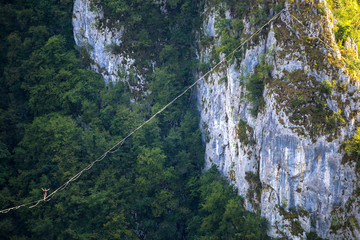 A man walks confidently along the highline.