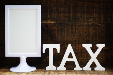 time to pay tax concept tax alphabet letters on wooden background