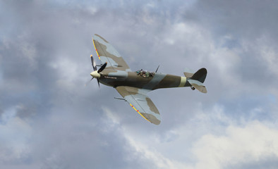 Fototapeta na wymiar vintage war plane flying in the sky