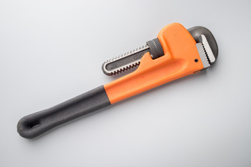 Pipe wrench on grey background