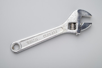 Adjustable spanner on grey background