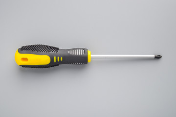 Screwdriver on grey background