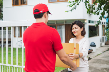 Asian delivery man deliver box parcel package to customer at home, shipping delivery concept
