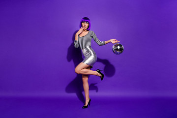 Fototapeta premium Full length photo of cute impressed person shout unbelievable wear eyeglasses eyewear hold mirror ball isolated over purple violet background