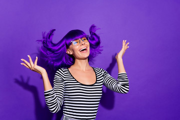 Portrait of charming youth raising hands palms close eyes isolated over purple violet background