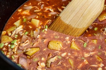 Closeup of a cast iron pot of homemade Brunswick stew 