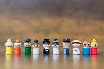 Wooden doll with  happy face on wooden background.