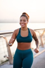 Fototapeta na wymiar Beaming woman working on weight loss running fast