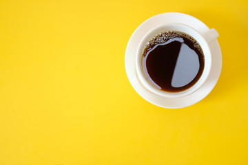 A cup of coffee on yellow background