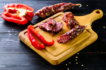Grilled sausages with vegetables close up on an old table